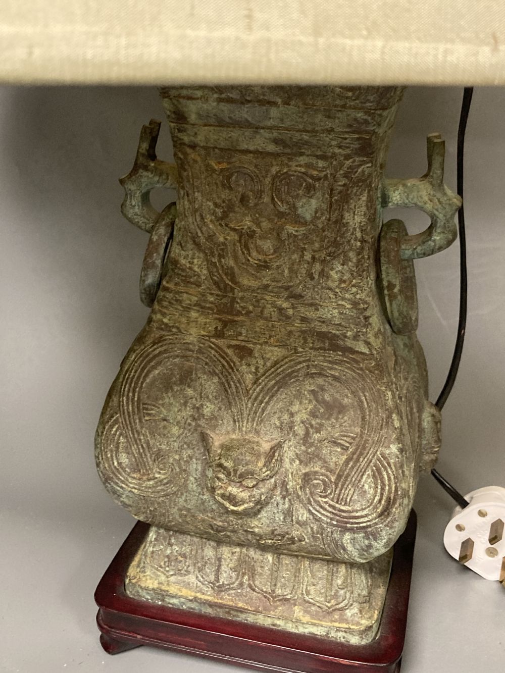 A pair of Chinese bronze lamp bases, in Zhou dynasty style, 36cm high excluding light fittings